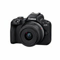 Canon EOS camera with lens on a white background